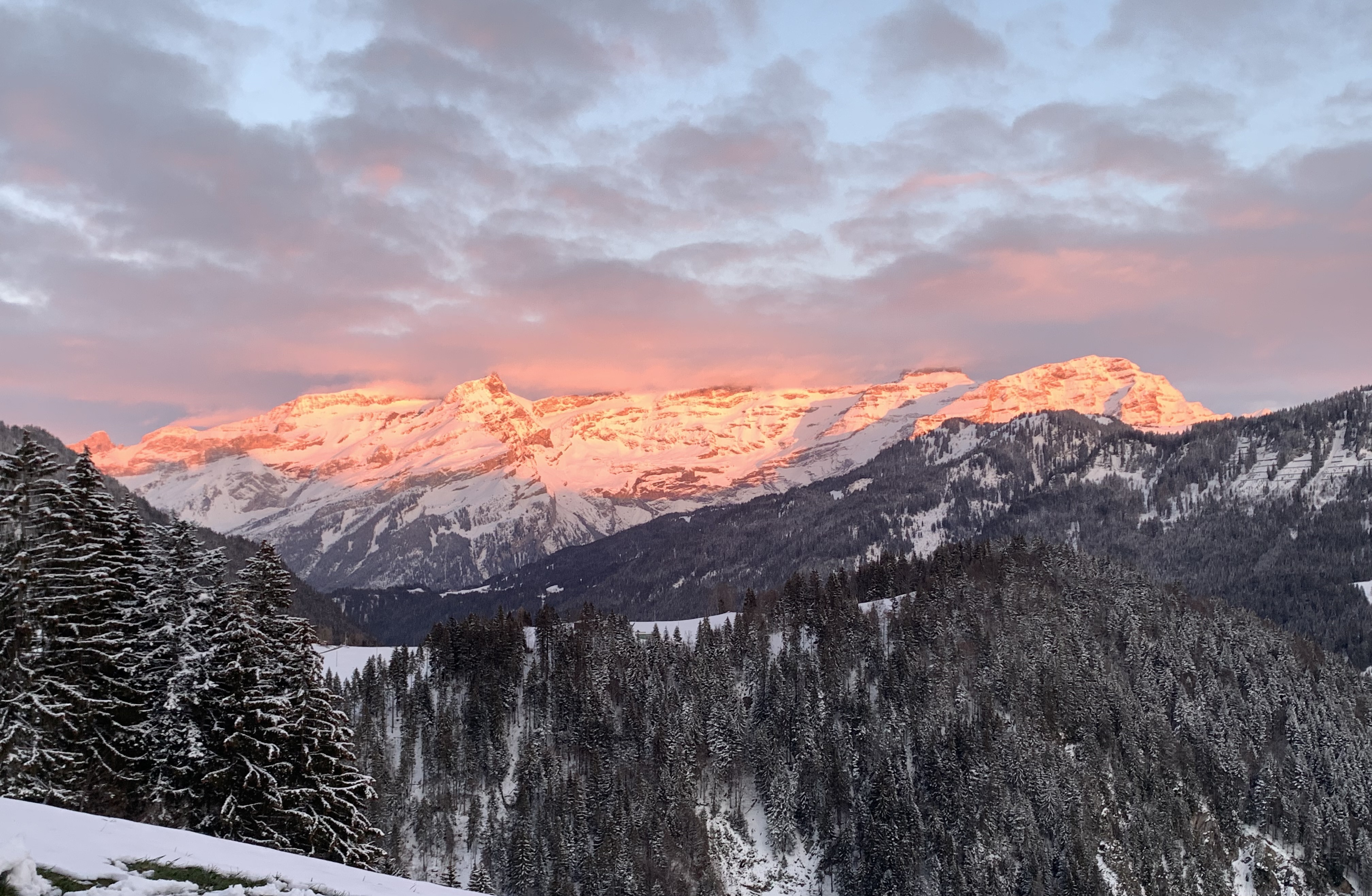Coucher de soleil sur les cimes enneigées des Alpes suisses pour une séance de coaching - Bas les masques